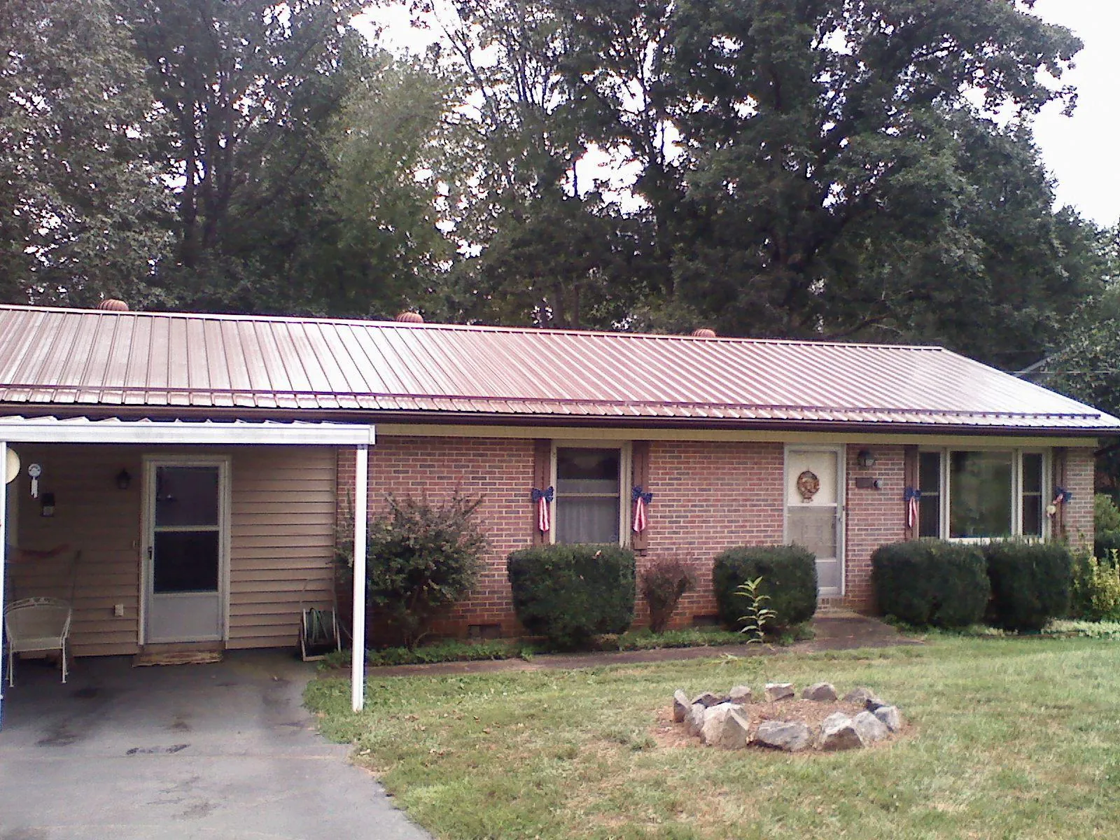 Bronze metal roof and carport on a brick ranch home — Roof Repair work by our crew in Long Pond