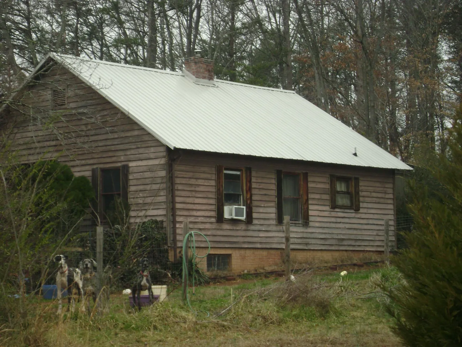 White metal roof on an old wood sided farmhouse, from a Metal Roof Installation job in Long Pond